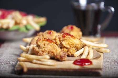 Fried chicken legs with french friesの写真素材