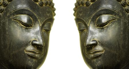 The two faces of antique Balinese Buddha statues set on a white background.の写真素材