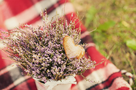 Beautiful wild flowers in a vase on a plaidの写真素材