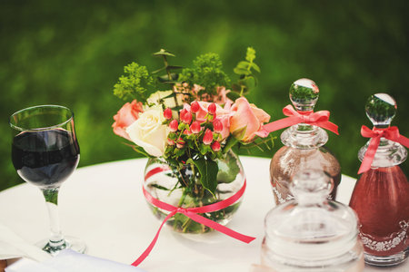 Beautifully decorated table with flowers and a glass of wineの写真素材