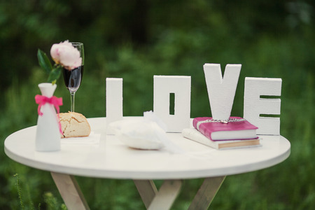 Beautiful white letters of the inscription love on the tableの写真素材