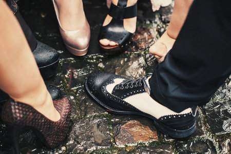 One male black and white shoes among many women