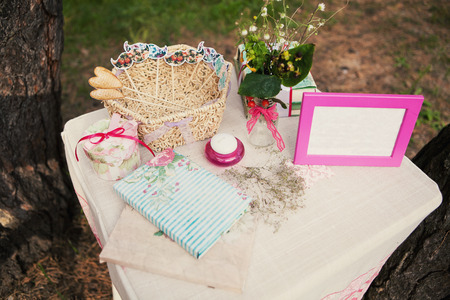 Beautiful decor on the table with a photo frame and flowersの写真素材