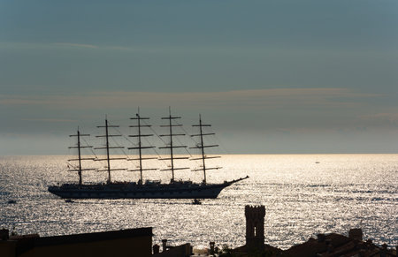 Large sailboat sailing into the sunset