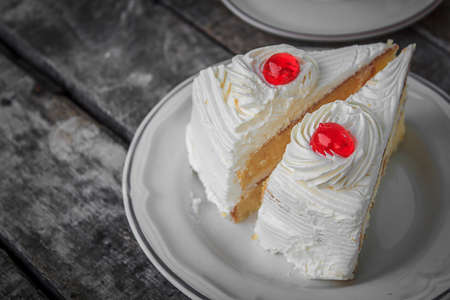 red cherry on cake sliceの写真素材