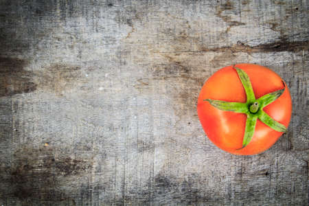 fresh tomato on old woodの写真素材