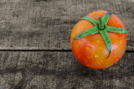 fresh tomato on old woodの写真素材