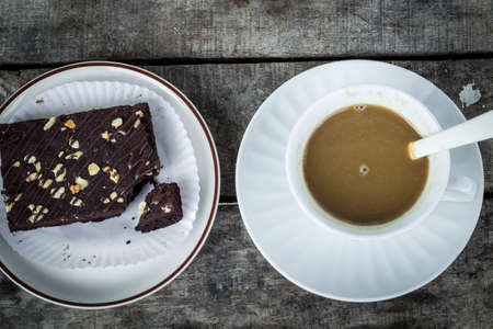 Closeup brownies with coffee cup on a tableの写真素材