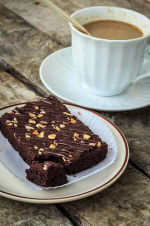 Closeup brownies with coffee cup on a tableの写真素材