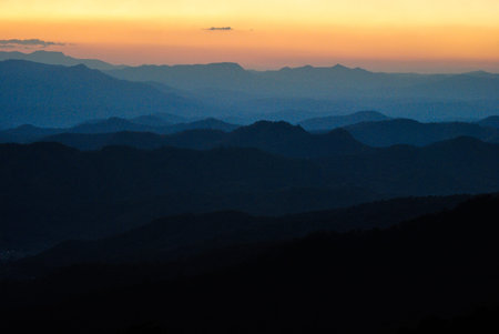 sunset and blue mountain at Phuping Palace in Chiang Mai, Thailand