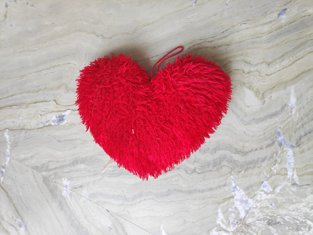 One heart shape cushion on marble