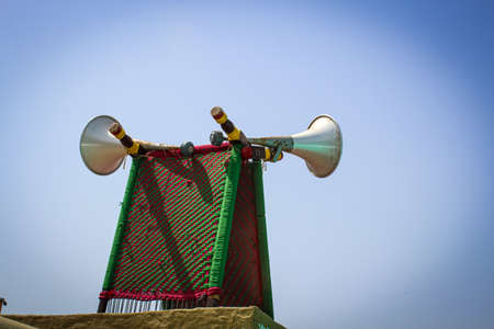 old-fashioned loudspeaker on blue sky backgroundの写真素材
