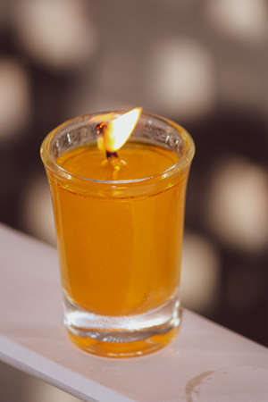 A beautiful glass candle glowingの写真素材