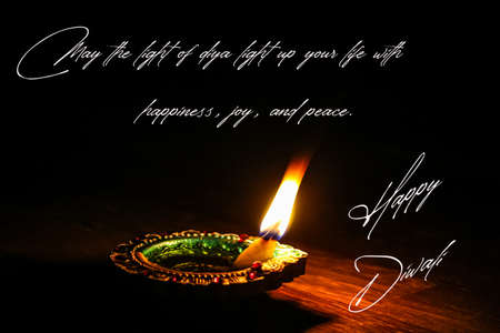 happy Diwali wishes with burning Diya on the black backgroundの写真素材