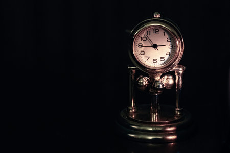 An old vintage clock with black background