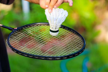 A closeup of badminton racket and white shuttlecockの写真素材