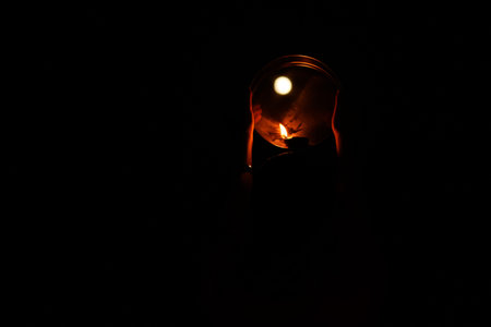 Karwa Chauth pooja burning candle against the moon on black background