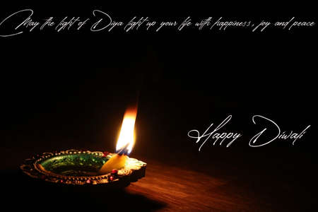 Illustration of happy Diwali wish card greeting with a glowing oil lampの写真素材