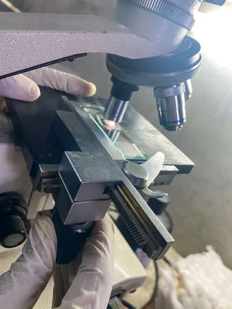 A view of a scientist working on a microscopeの写真素材