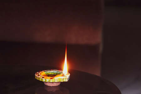 A burning oil small lamp flame in the dark for Diwali, Christmas, new year, celebration, occasionの写真素材