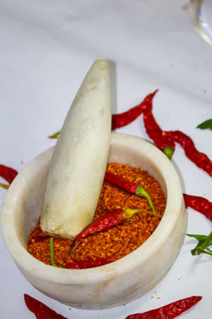 hot dry  red chilli pepper and  powder in a motor pestleの写真素材