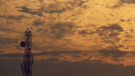 landscape view of the cloudy sky during the sunset with the communication towerの写真素材