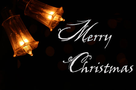 Merry Christmas card wish banner message greetings with bells lightsの写真素材