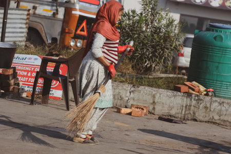 women worker  cleaning the street with a broomのeditorial素材