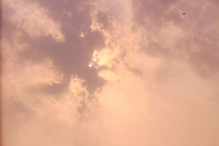 beautiful landscape view of sunlight emerging out of the clouds in the skyの写真素材
