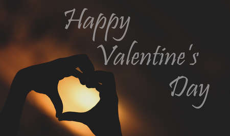 Illustration of Happy valentine day silhouette of a heart with hands poster card banner greeting messageの写真素材