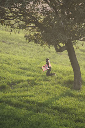 a child  running in the fields with kites in handの写真素材