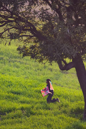 Bulhowal, Punjab/ India-12 28 2018 boy running in the fields with kites on his backのeditorial素材