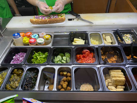 making of healthy salads with different vegetables bowlの写真素材