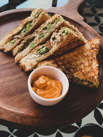 Grilled veg sandwich with a tandoori side dipの写真素材