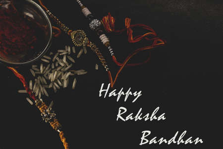 Illustration of Happy Raksha Bandhan banner card poster wishes greeting with rakhi's rice thread tilak in the plateの写真素材
