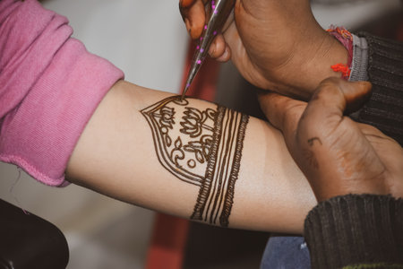 View of a person's hand drawing tattoo on the woman's handの写真素材