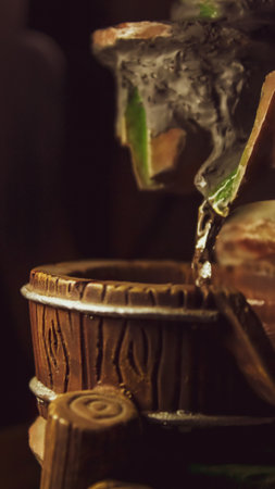 closeup of water pouring into a drum home decor fountainの写真素材