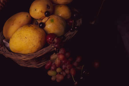still life with fruits grapes and pears in the basketの写真素材