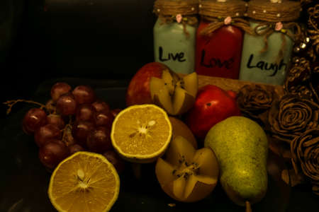 still life with fruits apple kiwi pear mausmbi with black backgroundの写真素材
