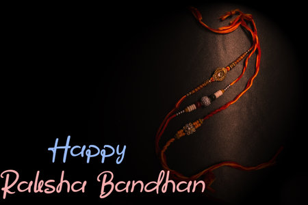 Happy Raksha Bandhan with raakhi threads spotted with light greeting wishes card banner posterの写真素材