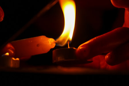 closeup of hands lightning burning candle on the occasion of Diwali festivals banner cardの写真素材