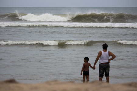 father and son playing on the beach at the sea in the evening. Father's day. Family Outingの写真素材