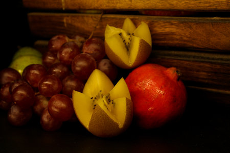 Fruit still life on a black background in a wooden box.の写真素材