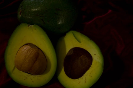 Avocado fruit on a red background. Close-up. Selective focus.の写真素材