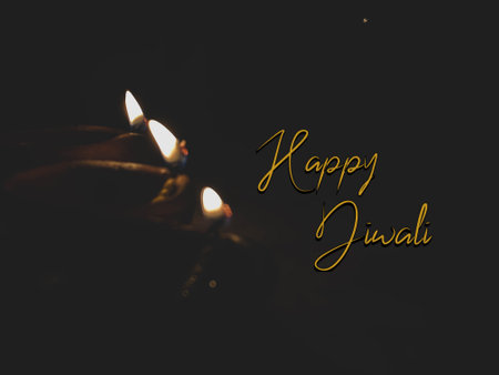 Happy Diwali text with burning candle on black background, selective focus greeting wishesの写真素材