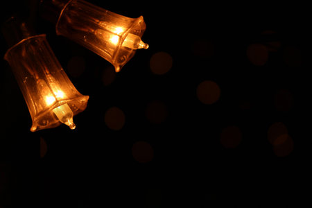 Close up of festive light bulbs on a black background with bokeh. Diwali specialの写真素材