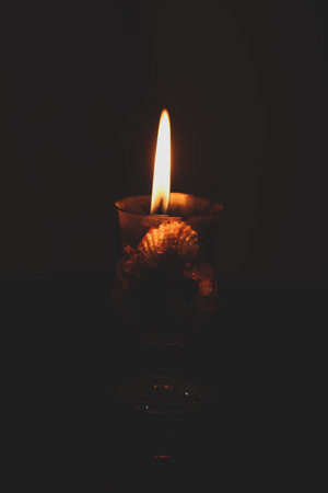 Burning candle on a dark background. Selective focus. Toned. Festival Celebration Diwali Candlesの写真素材