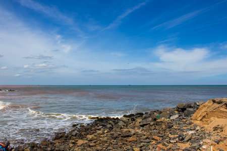 Beautiful landscape on the beach with rocks and blue sky. Coast of the Arabian Sea, Pondicherry, Indiaの写真素材