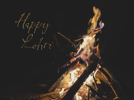 Happy Lohri written on a huge bonfire with copy space for text. Punjabi Lohri festive celebrationの写真素材
