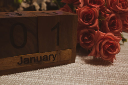 Happy New year with Wooden cube calendar with date January 01 and bouquet of roses. New year Date Special unique conceptの写真素材